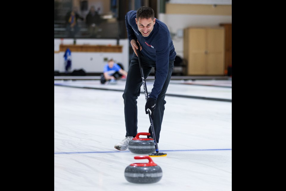 Olympic champion John Morris checks his line as he sweeps a rock into the house during a match at the Rocky Mountain Mixed Doubles Classic at the Canmore Golf and Curling Club on Friday (Jan. 5). JUNGMIN HAM RMO PHOTO 
