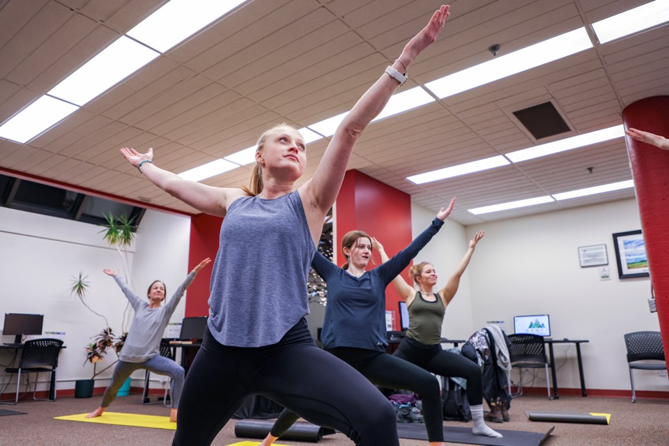 Participants take in a deep breath and stretch it out during Yoga at the Library at Banff Public Library on Friday (Jan. 5). The class mixes exercising the body and mind, as participants share their favourite books with each other. JUNGMIN HAM RMO PHOTO 