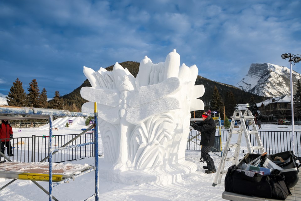 Ken Anderson carves a giant snow sculpture at Banff Community High School named " Dragonfly" for the SnowDays Winter Festival on Friday (Jan. 19). SnowDays Winter Festival runs Jan. 19 - Feb. 4. JUNGMIN HAM RMO PHOTO