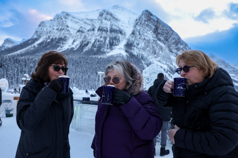 Teresa Brown, left, Peggy Watson and Karen Womask from North Carolina savour hot chocolate at an ice bar constructed from 20 blocks at Fairmont Chateau Lake Louise on Friday (Jan. 26). JUNGMIN HAM RMO PHOTO 