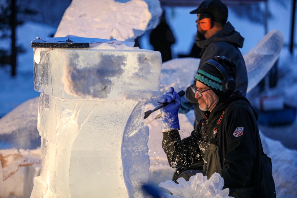 Ice carver Kevin Roscoe from Seattle, Washington uses a steel blade to create the shape with the theme,"It's not about the destination, eh" at the Lake Louise Ice Magic festival on the grounds of the Fairmont Chateau Lake Louise on Friday (Jan. 26). JUNGMIN HAM RMO PHOTO 