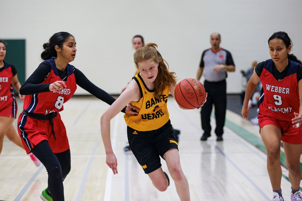 Banff Bears Stella Geestman (No. 9) drives to the hoop against the Webber Academy Wildcats during the Rocky Mountain Classic senior girls basketball tournament at Canmore Collegiate High School on Friday (Feb. 2). JUNGMIN HAM RMO PHOTO