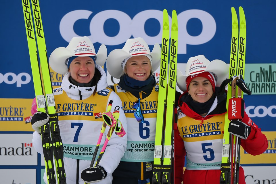 The podium of the women's 20km mass start classic, Finland's Kerttu Niskanen (silver), left, Sweden's Frida Karlsson (gold), middle, and Norway's Heidi Weng (bronze), right, stand together at the COOP FIS Cross-Country World Cup at the Canmore Nordic Centre on Sunday (Feb. 11). MATTHEW THOMPSON RMO PHOTO