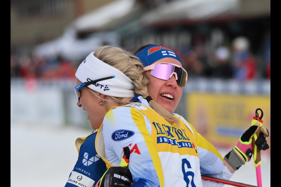 Findlan's Kerttu Niskanen, right, and Sweden's Frida Karlsson, left, hug after wining second and first in the women's 20km mass start classic at the COOP FIS Cross-Country World Cup at the Canmore Nordic Centre on Sunday (Feb. 11). MATTHEW THOMPSON RMO PHOTO