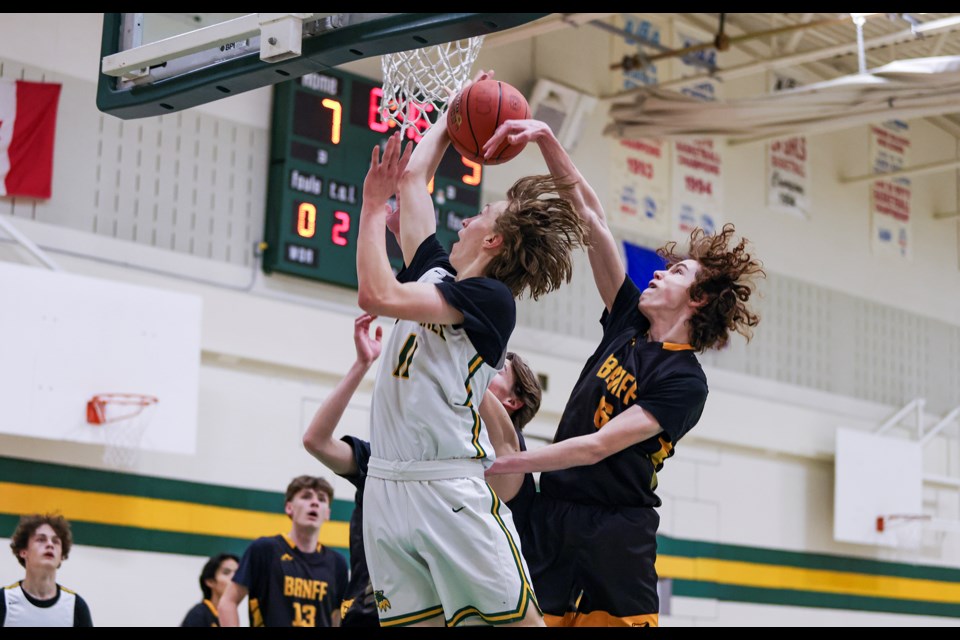 Banff Bears Leo Johnson (No. 6) blocks a layup attempt by Canmore Wolverines Cody Oruski during a game at Canmore Collegiate High School on Wednesday (Feb. 14). Wolverines won 90-72. JUNGMIN HAM RMO PHOTO