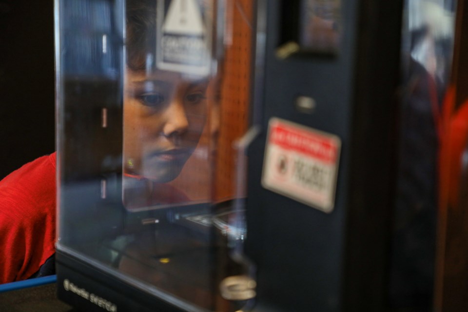 Lev Fuentes watches how a 3D printer works at the 3D printing class for kids as part of 3D Print Day at Canmore Public Library on Thursday (Feb. 22). JUNGMIN HAM RMO PHOTO