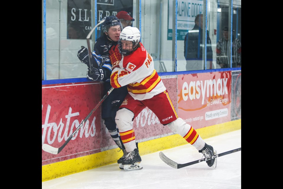 Canmore Eagles forward Owen Jones is bodychecked into the end boards by Calgary Canucks defenceman Nolan Paquette during the final home game of the regular season against the Calgary Canucks at the Canmore Recreation Centre on Tuesday (Feb. 27). The Eagles lost 6-1. JUNGMIN HAM RMO PHOTO