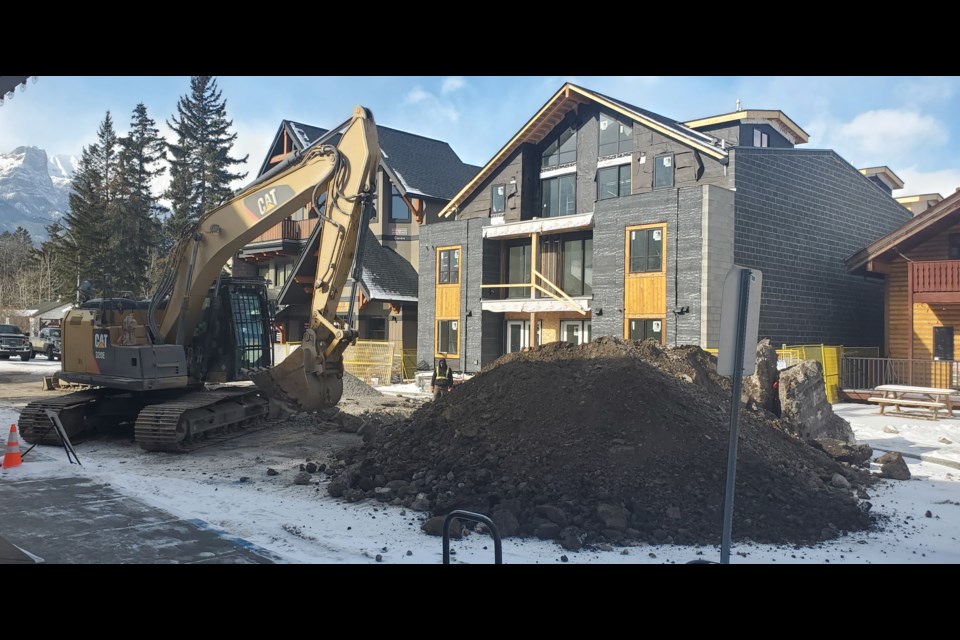 A construction crew works to service a new visitor accommodation building on 10th Street on Tuesday (Feb. 27). GREG COLGAN RMO PHOTO