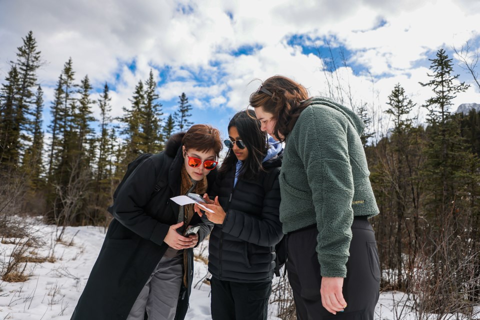 Katie Wilson, left, Anoushka Thakkar and Holly Aubichon discuss how they relate to a connection with nature in the Reflection through Connection event hosted by Canmore Young Adult Network (CYAN) and Howl at Larch Island in Canmore on Tuesday (March 12).  JUNGMIN HAM RMO PHOTO