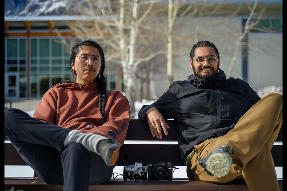 The teachers of the revived Through the Lens program, Soloman Chiniquay, left, and Nic Latulippe, right pose for a photo in front of the the Banff Community High School in Banff on Thursday (March 14). MATTHEW THOMPSON RMO PHOTO