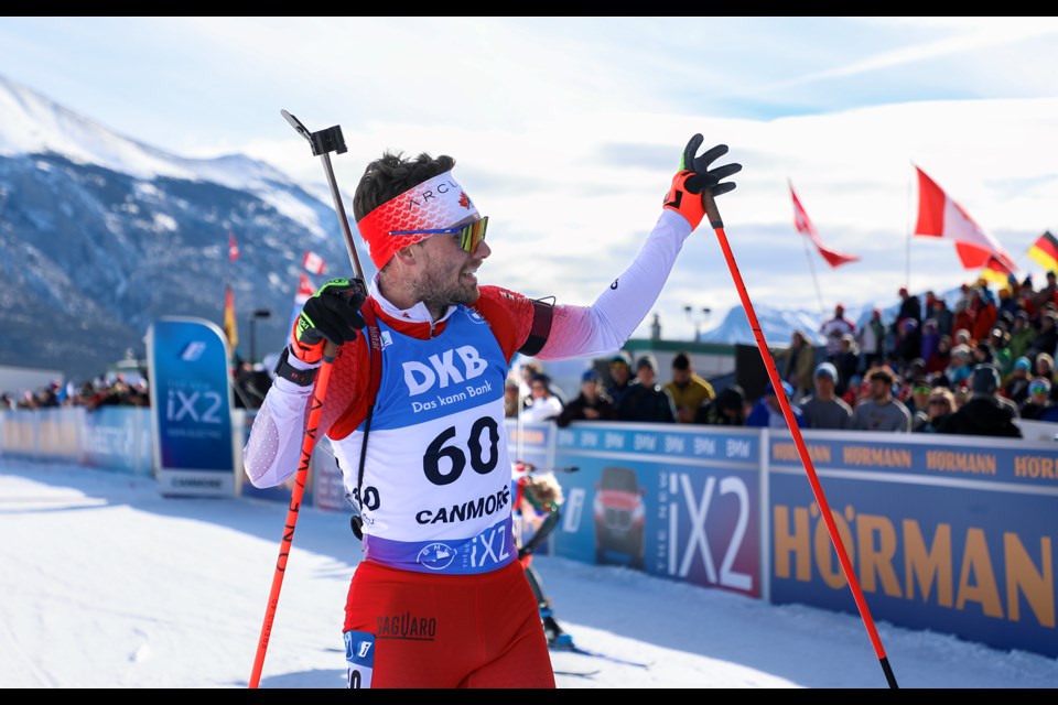 Following his final race on the World Cup, Canada's Christian Gow waves to the cheering squad after crossing the finish line in the men's 10km sprint at the IBU Biathlon World Cup at the Canmore Nordic Centre on March 15, 2024. JUNGMIN HAM RMO PHOTO