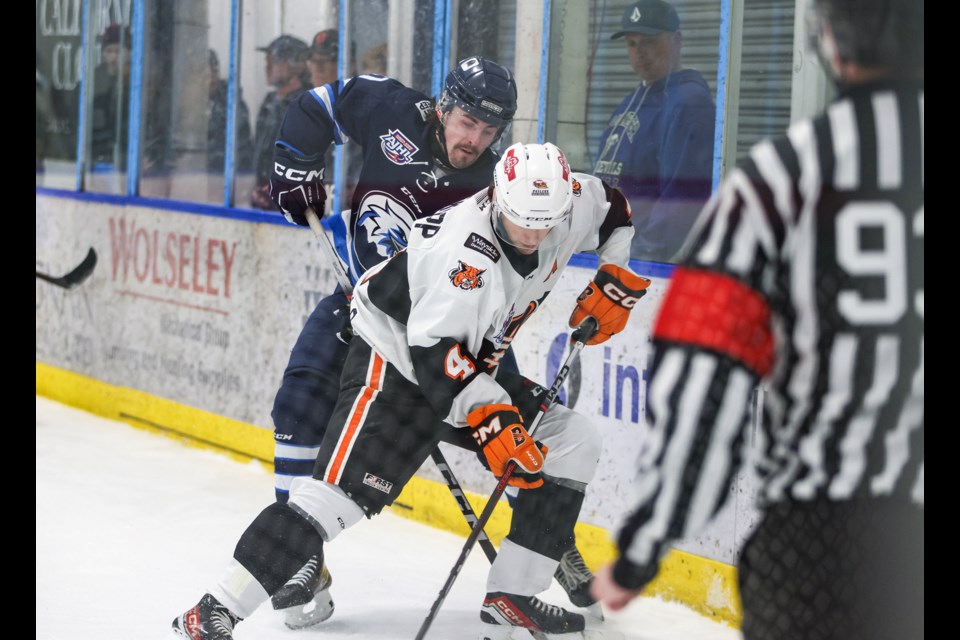 Canmore Eagles forward Nathan MacPherson-Ridgewell  fights for possession of the puck with Lloydminster Bobcats defenceman Ryan Redekopp during the Game 3 in AJHL playoffs at the Canmore Recreation Centre on Tuesday (March 19). The Eagles won 4-3. JUNGMIN HAM RMO PHOTO