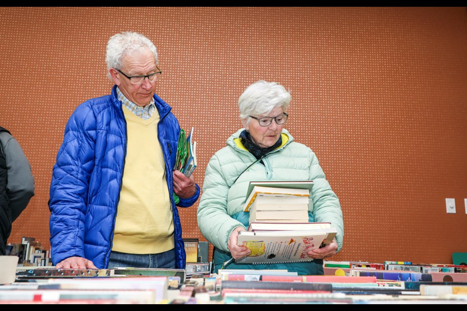 Lawrence Hill, left, and Joey Hill look over the books at the Friends of the Library spring book sale at Canmore Public Library on Friday (March 22). The spring book sale runs from Thursday to Sunday (March 21- 24) and the 2024 book sales are scheduled for March, July, and November. JUNGMIN HAM RMO PHOTO