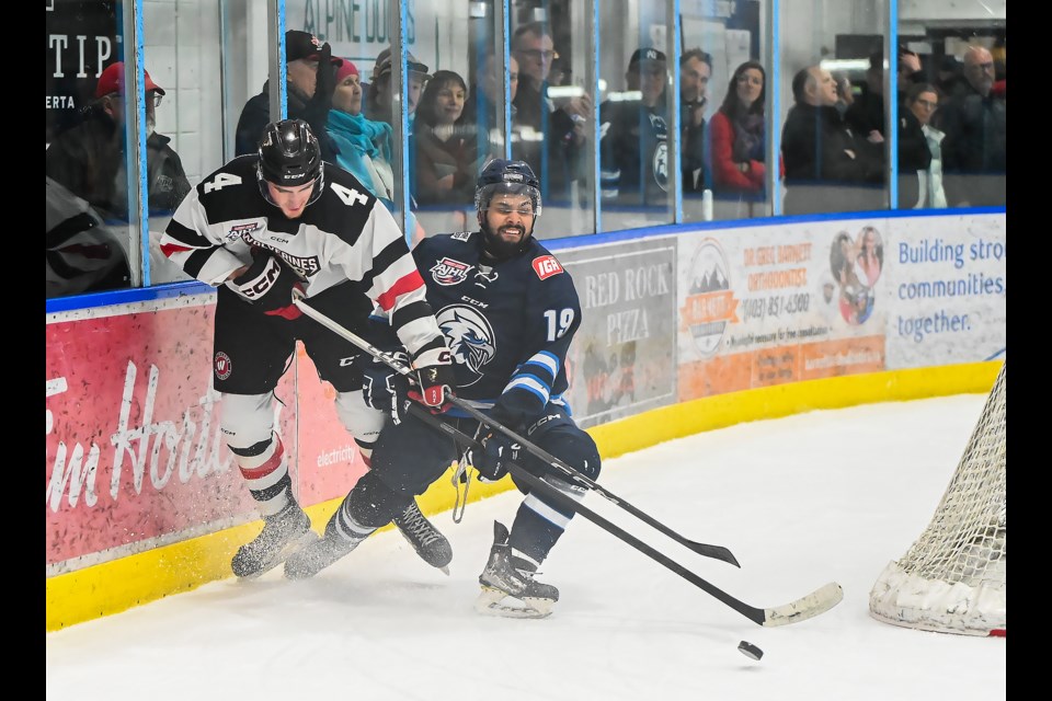 Canmore Eagles forward Kayden Rawji fights for the puck during a game against the Whitecourt Wolverines in Canmore on Tuesday (April 2). The Eagles lost 2-5 against the Wolverines. The series now favours the Wolverines 2-1. MATTHEW THOMPSON RMO PHOTO
