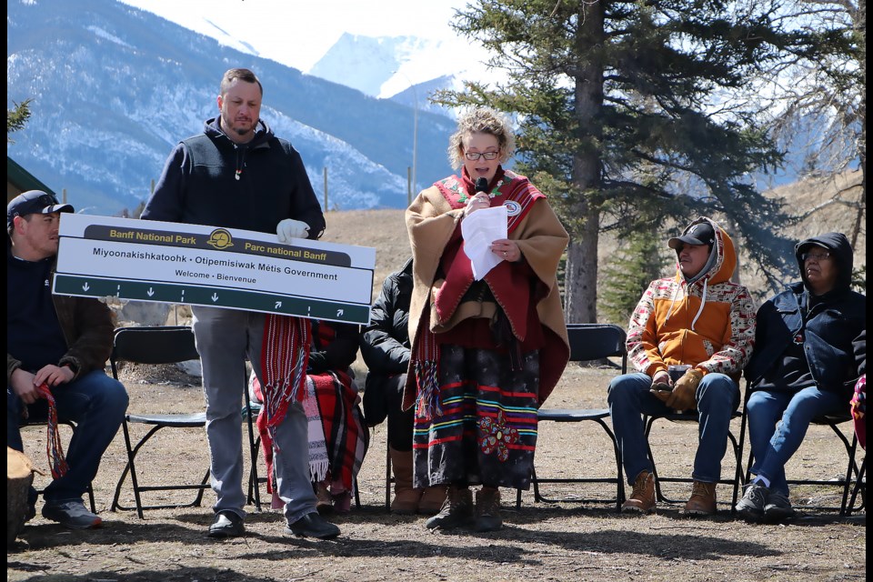 Amber Boyd, right, district captain of the Otipemisiwak Métis Government of the Métis Nation of Alberta, speaks during a celebration at Cascade Ponds day-use area to mark the launch of the Banff National Park Indigenous Advisory Circle's gantry sign initiative Wednesday (April 10). Going forward, the sign will welcome visitors into the park in Indigenous languages.

JESSICA LEE RMO PHOTO