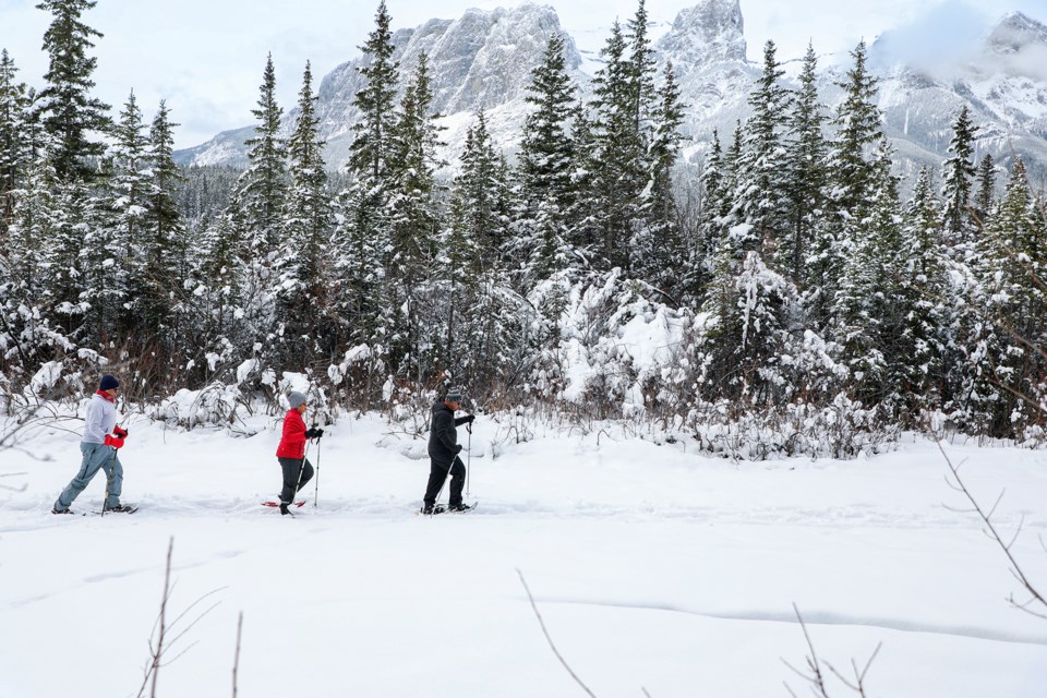 Snowshoers make their way through one of the snow-laden tributaries on Bow River in Canmore on Friday (April 5).  JUNGMIN HAM RMO PHOTO