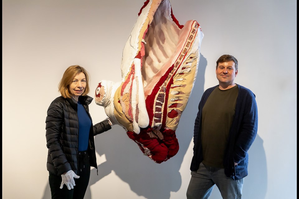 Lorrainne Simms, left, and Jude Griebel, pose for a photo with one of Tamara Kostianovsky's textile sculptures. SUBMITTED