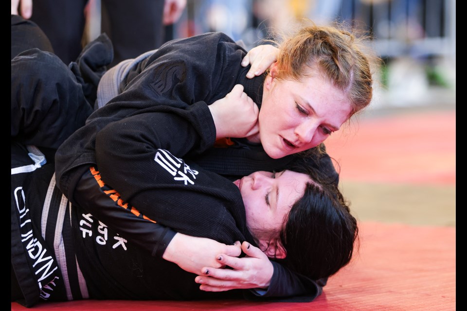 Dark Horse Martial Arts' Aven McKay, top, looks to get top position against Limitless BJJ Edmonton's Londyn Lefebvre during the Dark Horse Grappling Series, a submission-only jiu-jitsu tournament at Fenlands Banff Recreation Centre on Saturday (April 13. JUNGMIN HAM RMO PHOTO 