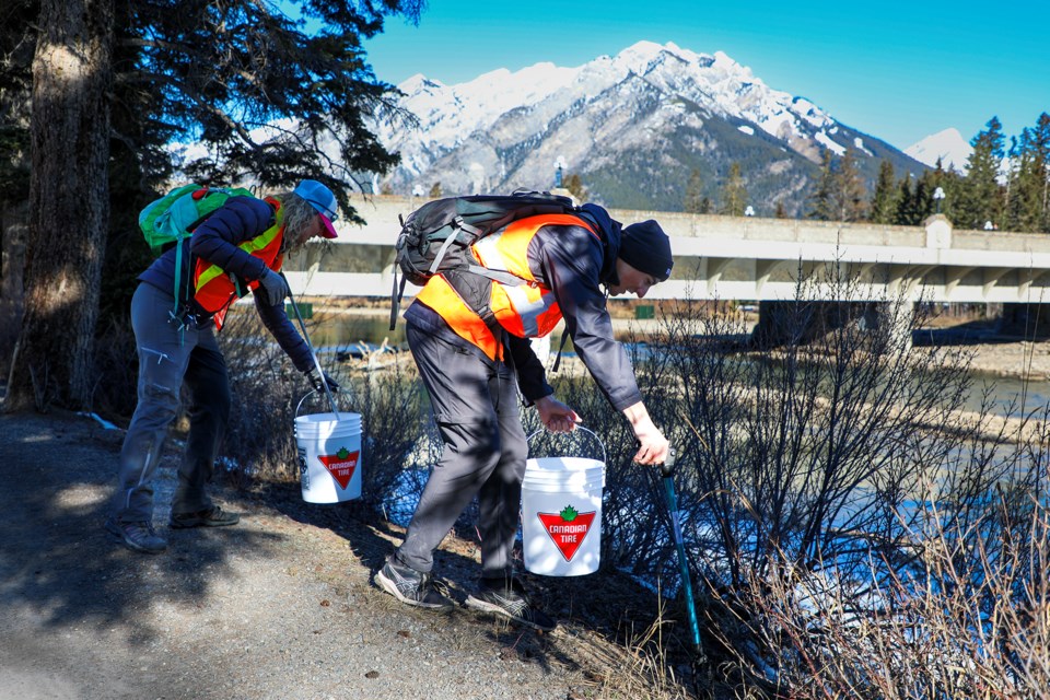 Mireya Rubio, left, and Harry Brierley pick up garbage around Bow River Trail during the community clean-up event to celebrate Earth Day in Banff on Saturday (April 20). JUNGMIN HAM RMO PHOTO