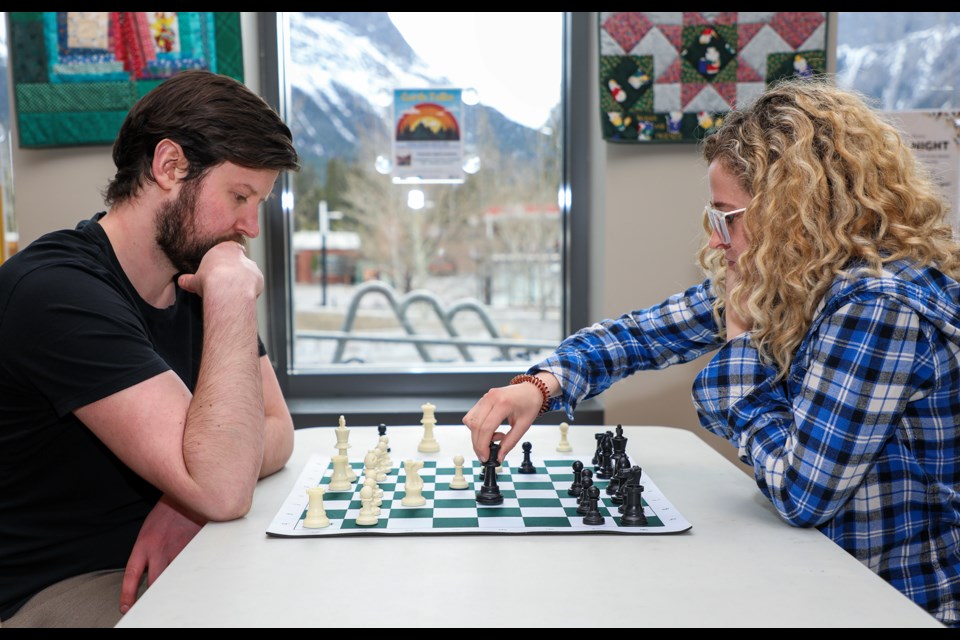 Alex McEwen, left, plays against Devyn Burstrom during Chess Night at the Canmore Public Library's friends program room on Thursday (April 25). Chess Night runs from 5 to 8 p.m. on Thursdays until June. JUNGMIN HAM RMO PHOTO 