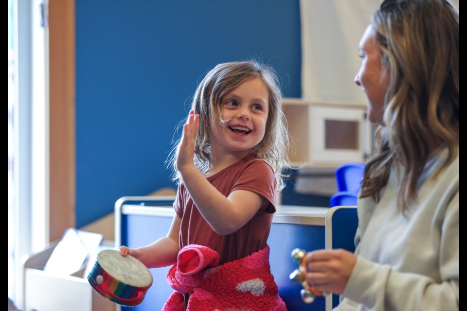 Rosie Donald dances while hitting a tambourine during music activities at the Spring Early Years Fair at Canmore Community Daycare Society on Saturday (May 4). JUNGMIN HAM RMO PHOTO