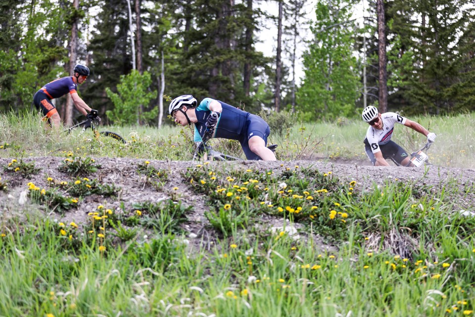 Canmore's Logan Sadesky, centre, rides down the trail during the 2024 Canmore Canada Cup XCO at the Canmore Nordic Centre on Wednesday (June 12). JUNGMIN HAM RMO PHOTO