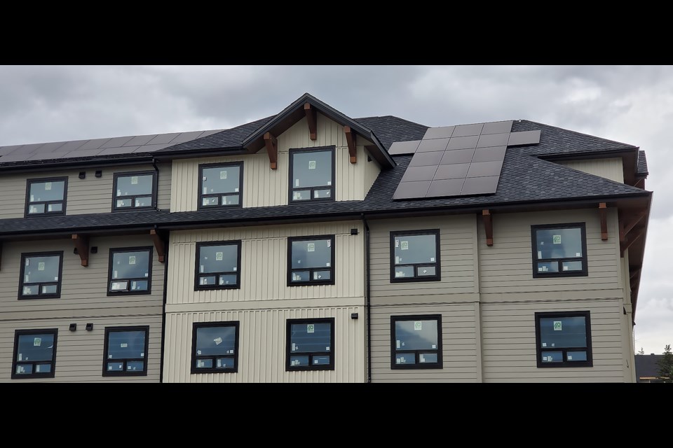 The mixed-use building at 500 Bow Valley Trail with solar panels on its roof. Construction is expected to finish this year, with it set for employee housing and Castle Mountain Home Furnishings. GREG COLGAN RMO PHOTO