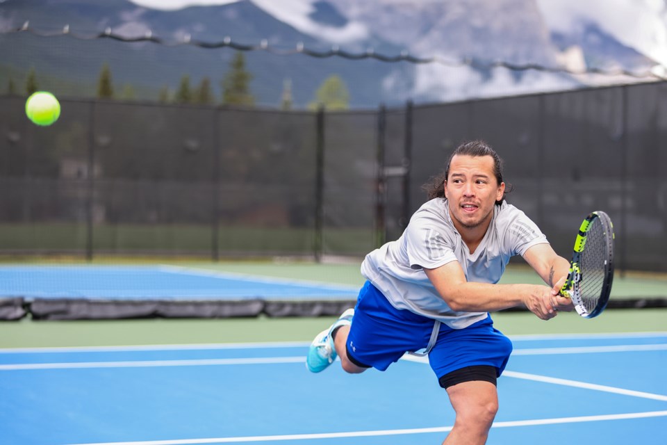 Diego Mora leaps for a backhand shot during the Canmore Tennis Association’s Mixed Doubles club championship match at Lions Park in Canmore on Saturday (Aug. 17).  JUNGMIN HAM RMO PHOTO