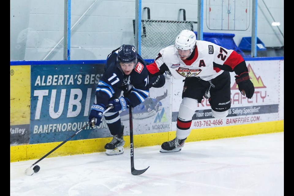 Canmore Eagles forward Owen Jones fights for possession of the puck with Camrose Kodiaks defenceman Avery Trotter at the Canmore Recreation Centre on Friday (Nov. 22). The Eagles won 5-1, snapping the Kodiaks eight-game win streak. JUNGMIN HAM RMO PHOTO
