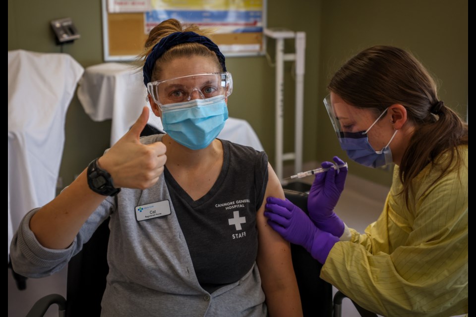 Registered nurse Julie Denouden gives Cat Harris, also a registered nurse, the second dose of the COVID-19 vaccine at the Canmore General Hospital on Wednesday (Jan. 6). LEAH HENNEL AHS PHOTO