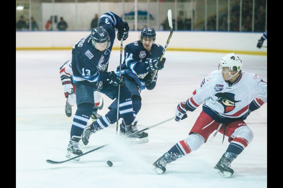Canmore Eagles centre Alex Young clashes with the Brooks Bandits last season. RMO FILE PHOTO