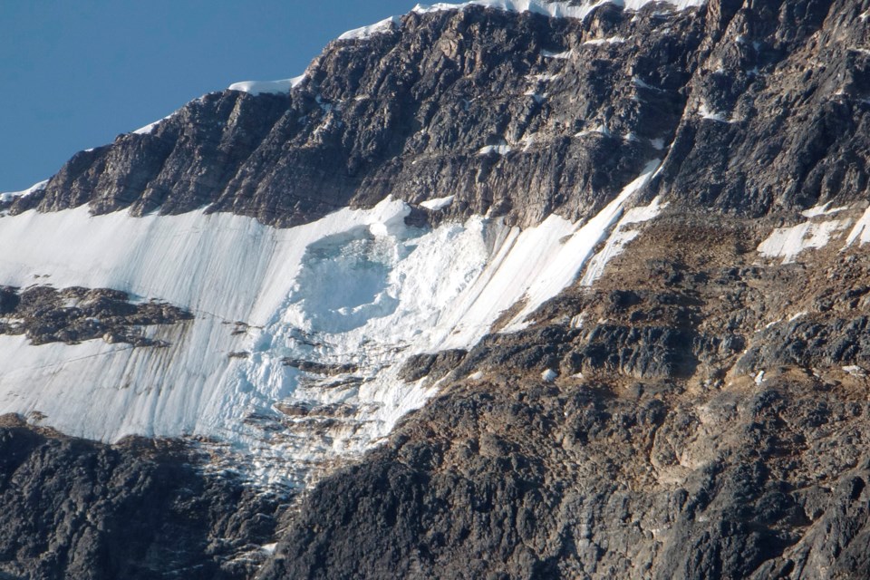 A chunk of the Ghost Glacier, pictured on Aug. 11, 2012, fell into Cavell Pond overnight. The incident created a wave that destroyed the nearby parking lot and road. PARKS CANADA PHOTO