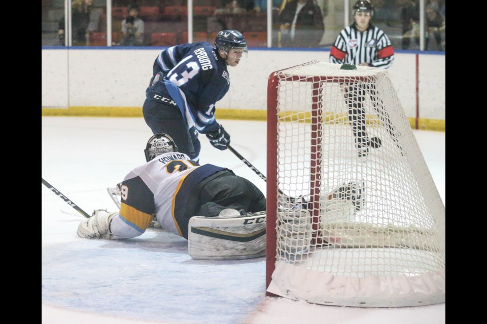 Canmore Eagles player Alex Young scores on the Calgary Mustangs during the 2018-29 season. RMO FILE Photo