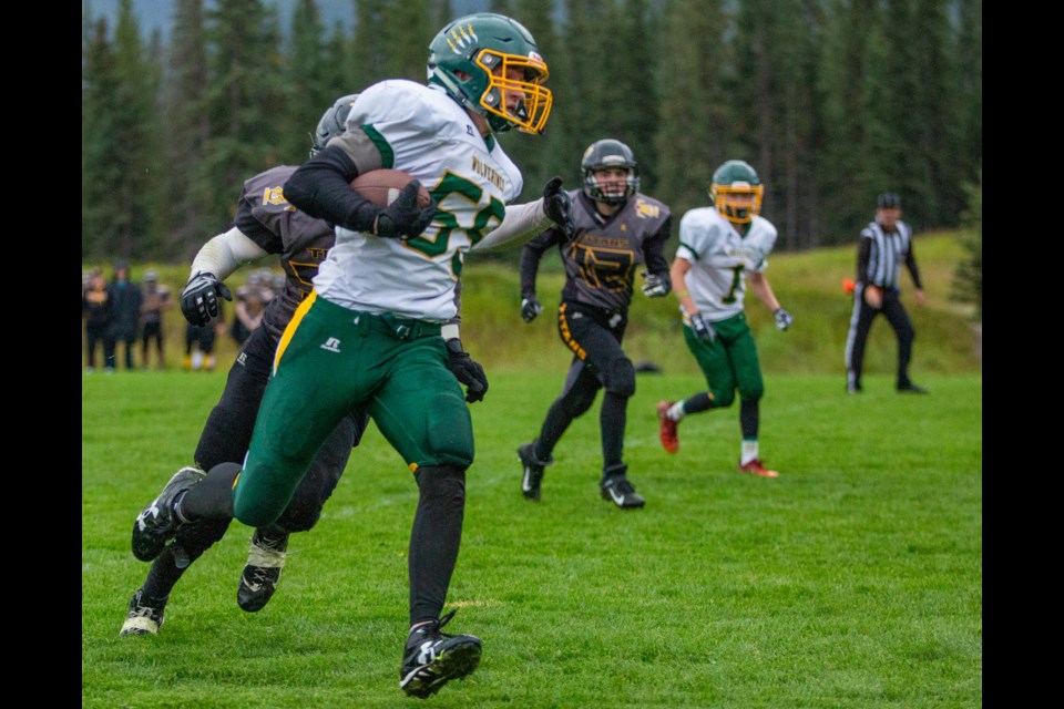 Canmore's Joshua Ellis holds off a Drumheller player as he returns a punt for the Wolverines first touchdown during a game at Millennium Field on Monday, September 9, 2019. EVAN BUHLER RMO PHOTO