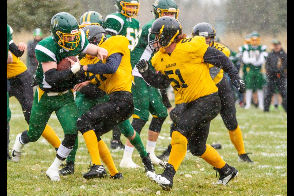 Wolverine Albert Reed, pictured here stiff arming an Olds lineman this season, went down with an injury in Saturday's (Nov. 8) playoff game against the Willow Creek Cobras. RMO FILE PHOTO