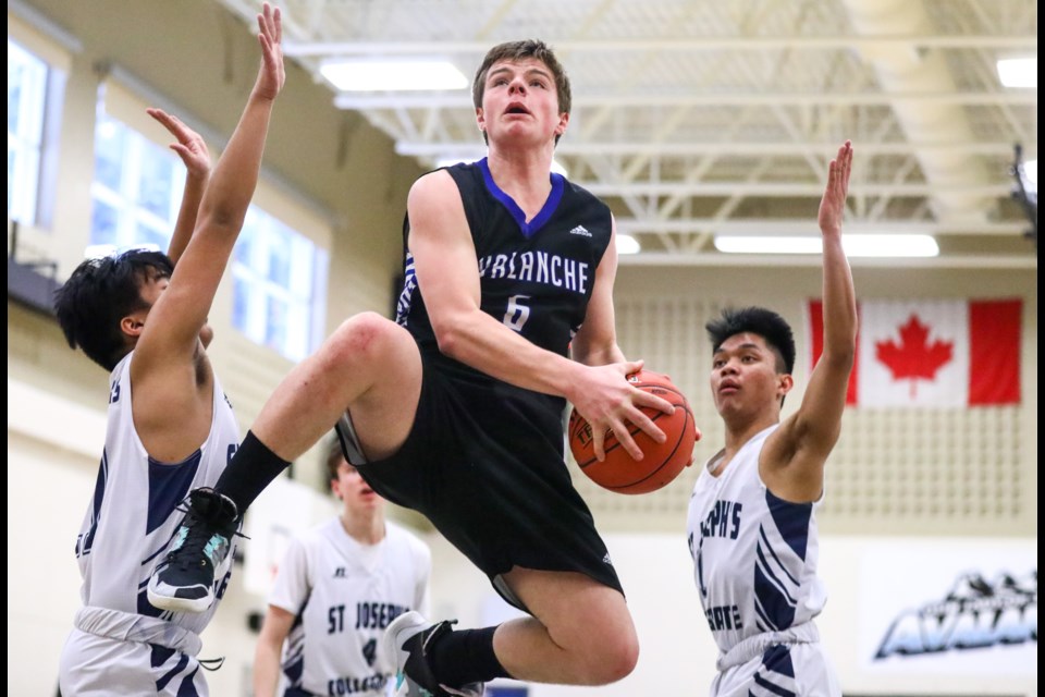 Avalanche's Justin Hughes soars through the air during the final game against in the tournament at OLS on Saturday (Feb. 8). EVAN BUHLER RMO PHOTO