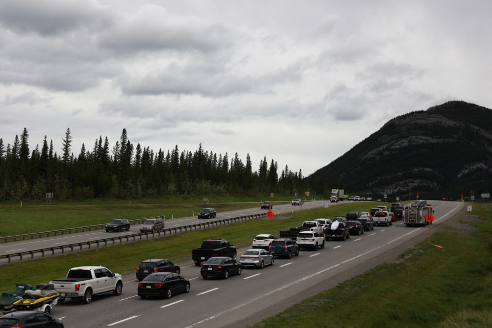 Vehicles are seen stopped on the Trans-Canada Highway Thursday (July 2) while emergency services respond to an injured cyclist. In order to allow STARS air ambulance to land, Canmore RCMP closed the highway temporarily. EVAN BUHLER RMO PHOTO 