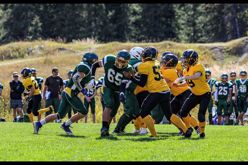 Canmore Wolverines' defensive lineman Keithan Simeon (No. 65) rushes the Olds Spartans o-line during the 2022 season. JUNGMIN HAM RMO PHOTO