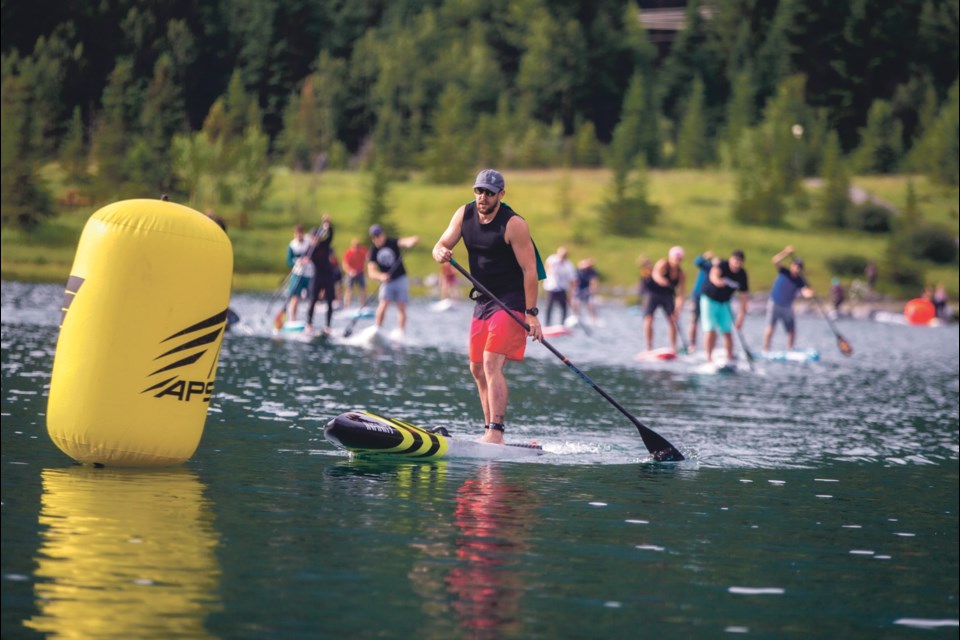 Chris Prince rounds the first buoy during the KCPO SUP Cup at Quarry Lake in Canmore on Sunday (July 14). Prince finished first overall in the race. (Aryn Toombs/Rocky Mountain Outlook).