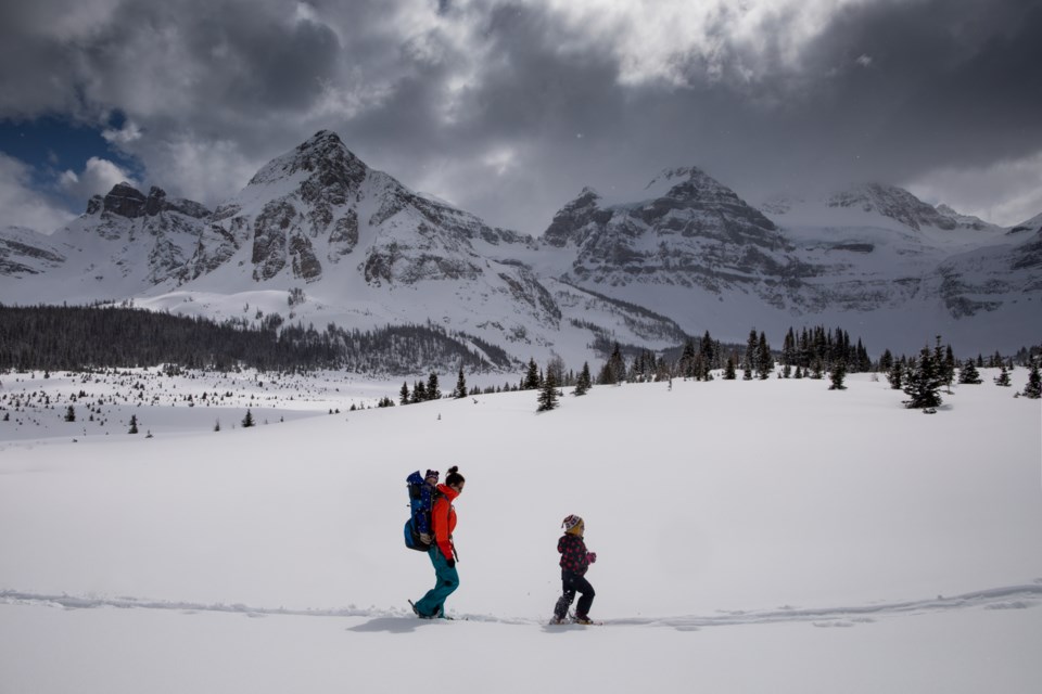 Banff author Meghan J. Ward and  her two children with the mighty Mount Assiniboine in the background. PAUL ZIZKA PHOTO