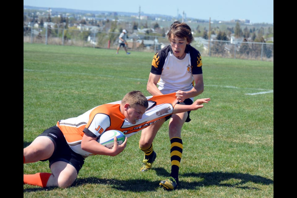 Banff Bears' Macsen Hempstead throws down a St. Francis Browns player at the Clearwater Cup Rugby Sevens tournament at Calgary Rugby Union park on Saturday (May 13). JORDAN SMALL RMO PHOTO