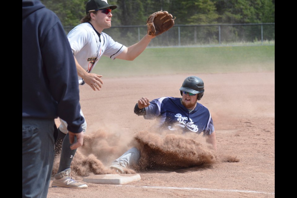 Bow Valley Blues Torin Young beats the throw and slides into third base against Calgary North 2 on Saturday (May 28) at Millennium Park in Canmore. JORDAN SMALL RMO PHOTO