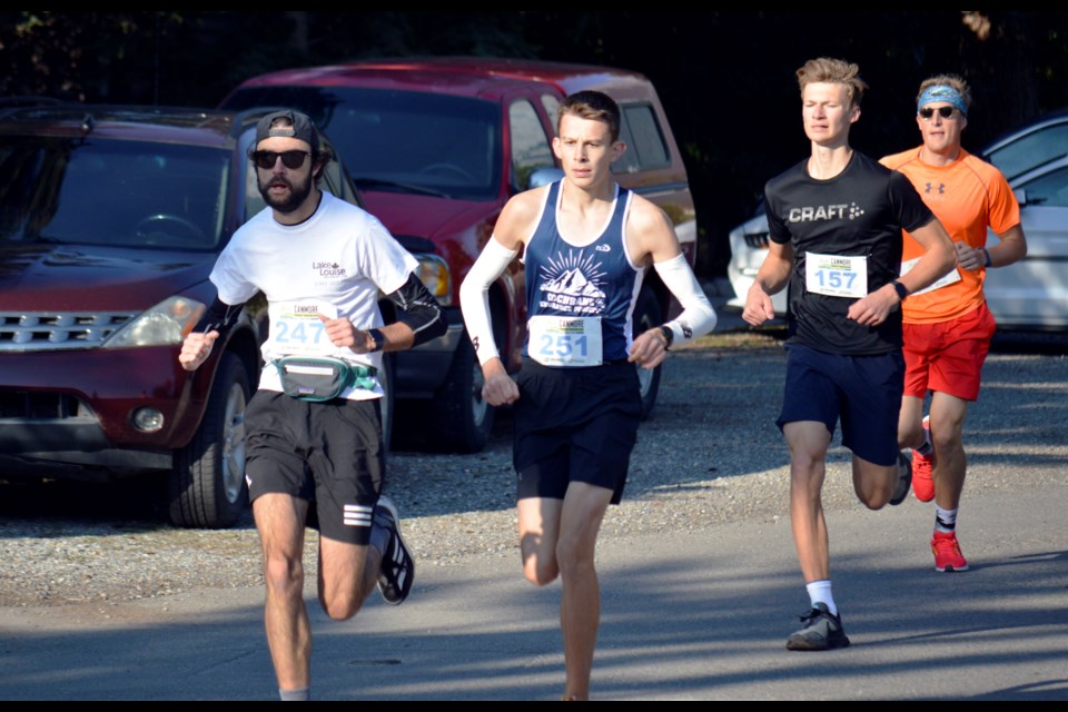 Five km runners Colin Christmas (247) of Lake Louise, Caden Jones (251) of Cochrane, Thomas Boruta (157) of Canmore, and Louis Johnson (119) of Calgary, separate themselves from the herd early in the 2022 Canmore Rocky Mountain Half Marathon, 10 KM, and 5KM. Jones won at a time of 19:23.1. JORDAN SMALL RMO PHOTO