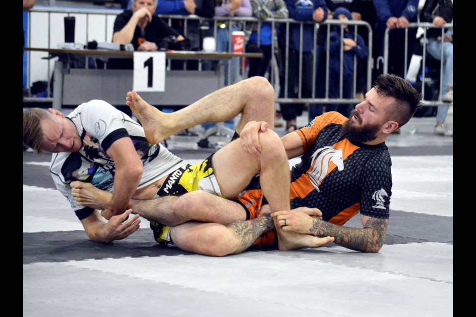 Canmore's Travis Erlam defends a heel hook against Blackfalds' Drew Weatherhead in a no gi super fight at the inaugural Dark Horse Grappling Series on Saturday (June 11) at Fenlands Banff Recreation Centre. JORDAN SMALL RMO PHOTO