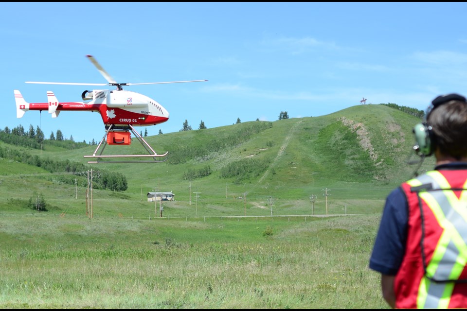 Principal Investigator Wade Hawkins watches the Swiss drone carry live viral test kits for the pilot project to deliver test kits from rural areas to urban centres, launched in Stoney Nakoda Nation from the Morley townsite on June 25, 2020.
JENNA DULEWICH RMO PHOTO