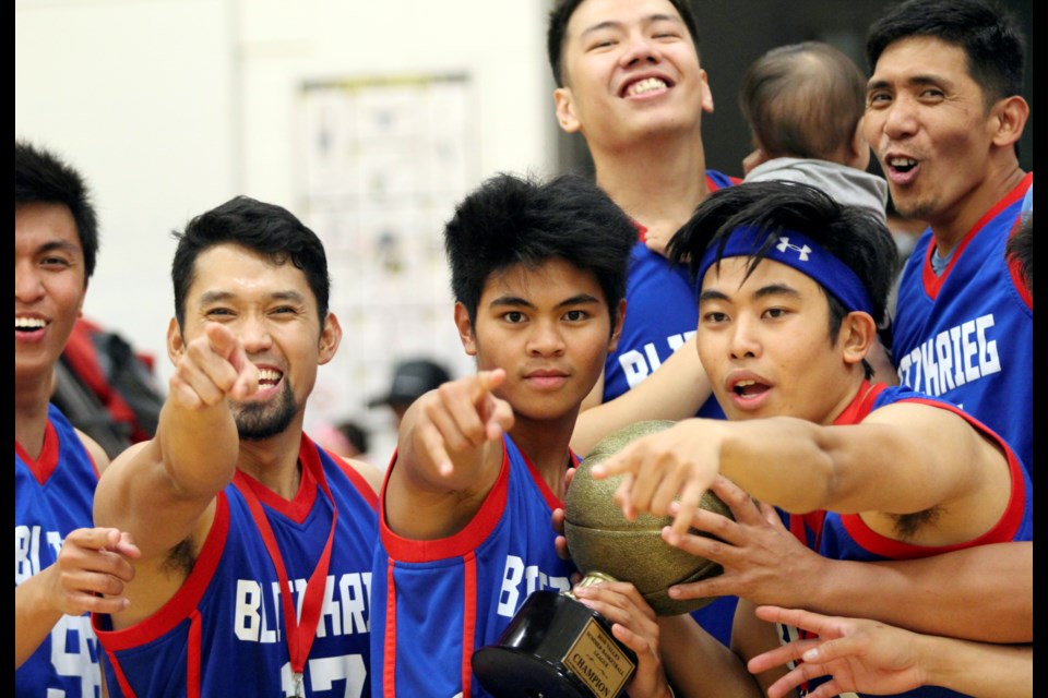 Members of Blitzkrieg celebrate with their Bow Valley Filipino-Canadian Basketball League championship trophy on Saturday (Aug. 10) in Banff. Blitzkrieg defeated Voyager Inn 81-58 in the finals. Jordan Small RMO Photo