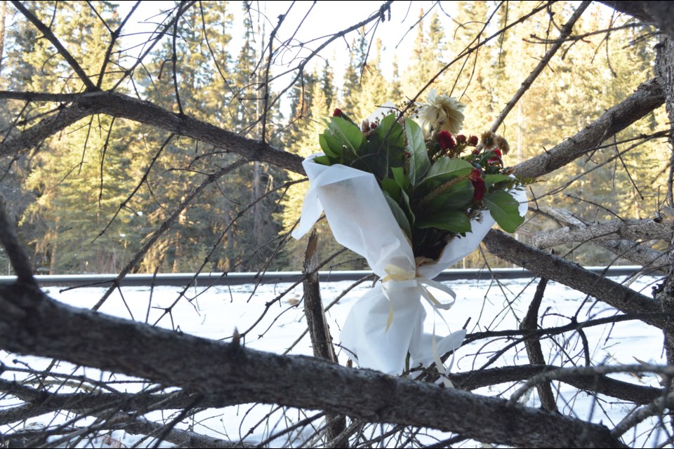 Flowers are left in a tree near the train tracks in Banff after Raven Sillito, also known River, was struck and killed on the tracks on Dec. 29. JORDAN SMALL RMO PHOTO
