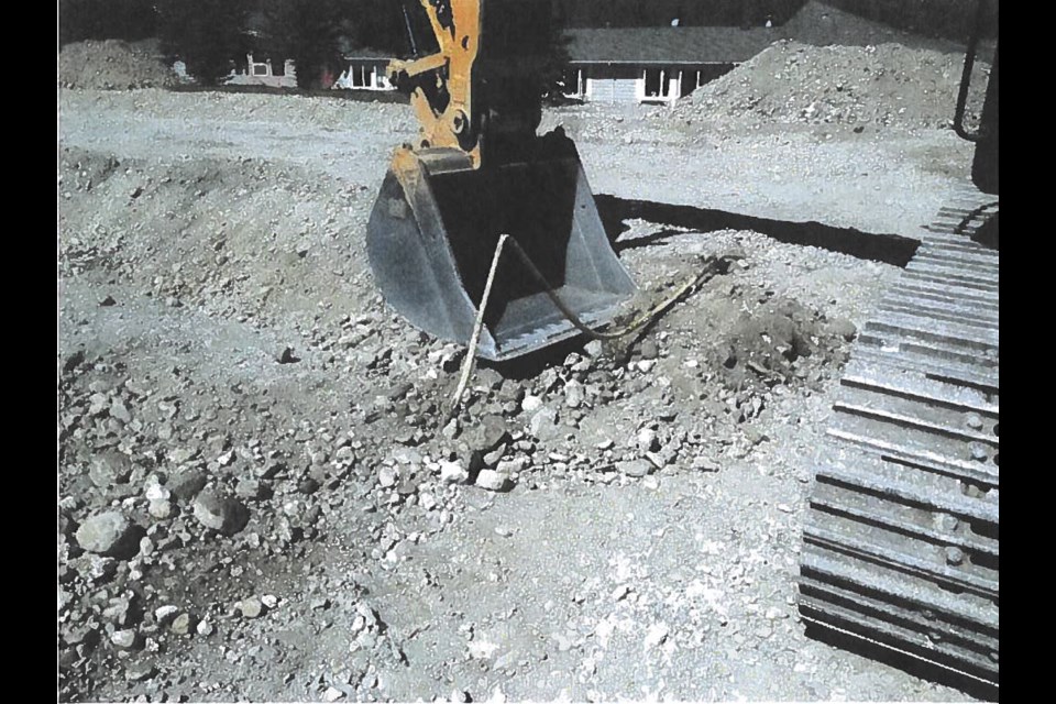 A photo of the workers digging above the T-Connection. 
SUBMITTED