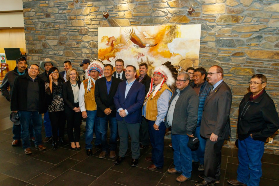 Premier Jason Kenney, Minister of Transportation Ric McIver, Minister of Indigenous Relations Rick Wilson, MLA for Banff-Kananaskis Miranda Rosin, MLA for Airdrie-Cochrane Peter Guthri, and Chiniki Chief Aaron Young, Wesley Chief Clifford Poucette and Bearspaw Chief Darcy Dixon gather with Stoney Nakoda First Nation residents during the announcement of funding to widen the 1A Highway on Tuesday (Nov. 12). CHELSEA KEMP RMO PHOTO