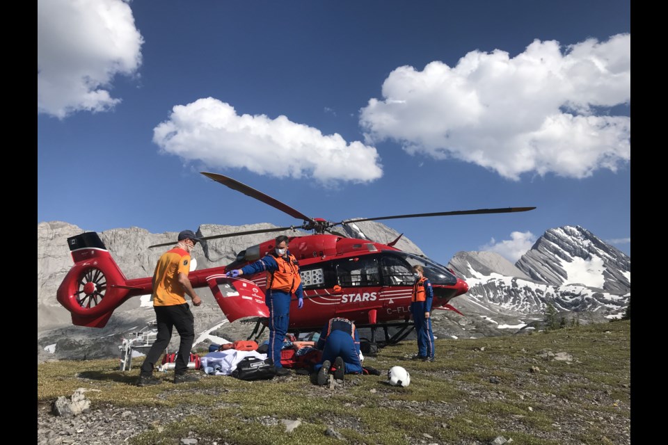 STARS air ambulance crew members assist an injured hiker in the Burstall Pass area. KANANASKIS PUBLIC SAFETY PHOTO